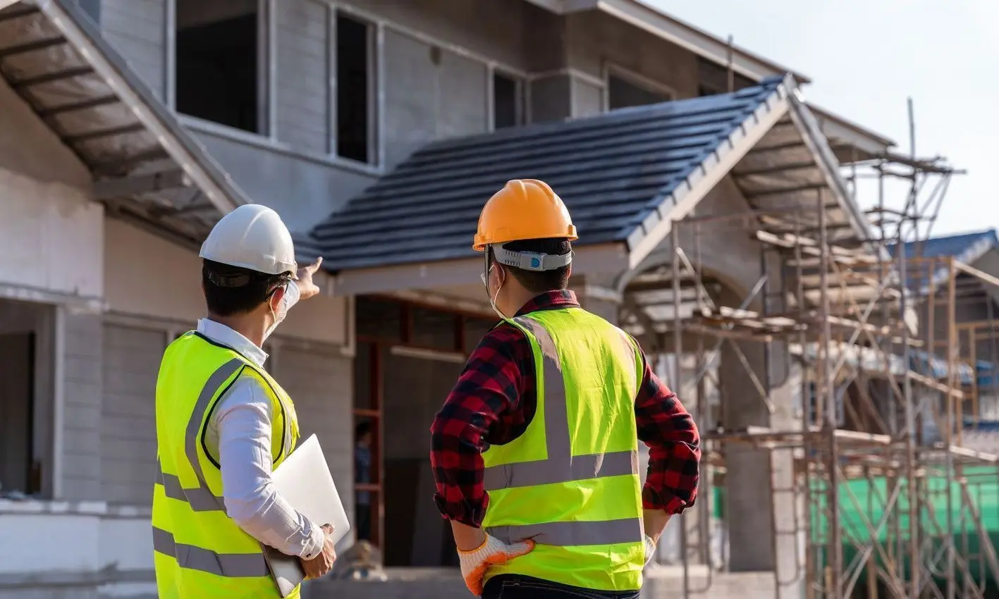 Inspectors reviewing a home's roof and exterior
